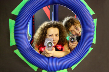  Portrait of mother and daughter (mr) with a laser-automats in laser tag at the shopping center...