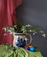 A still life arrangement of Easter eggs, spring flowers. Still life with snowdrops and ester eags. - 755693759
