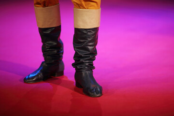 Theatrical sham soldier black leather boots on stage during performance
