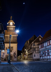 Street alley in the small town of Schwabisch Hall, with houses and buildings with typical German architecture and street lanterns, at night. - 755696967