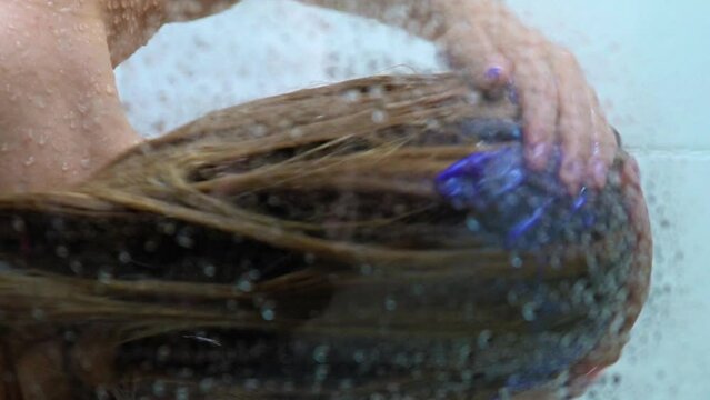 Young Slim Woman Taking A Shower And Washing Her Hair With Shampoo
