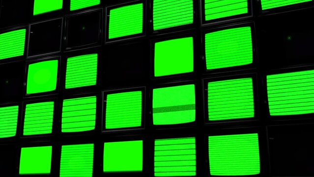 A Wall of TV Screens with Green Static in a Dark Setting. Chroma Key