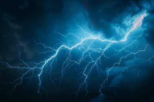 A striking image of a bright blue lightning bolt piercing through a dark sky. This powerful and electrifying photo captures the raw energy and intensity of a lightning storm. Perfect for illustrating 