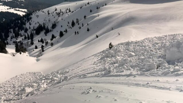 a powerful avalanche fell from an alpine slope in the Ukrainian Carpathians, huge blocks of snow are deadly for tourists, spring is coming.