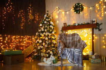 Christmas interior with presents under fir tree, plaids on chair near wall with garlands