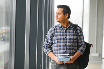 Portrait of cheerful male international Indian student with backpack. Education concept