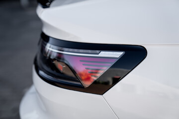 Modern car taillight from side view of a white car build