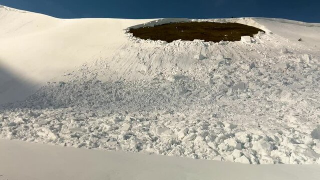 a powerful avalanche fell from an alpine slope in the Ukrainian Carpathians, huge blocks of snow are deadly for tourists, spring is coming.
