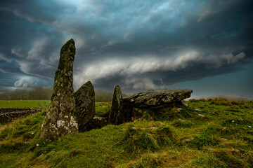 Prehistoric burial mound with stormy sky