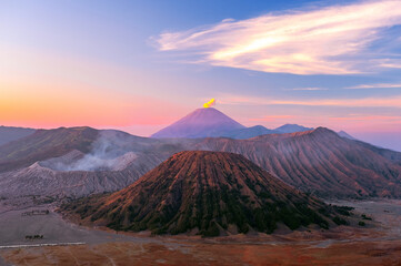 Magical view of Semeru and Bromo volcanoes erupting simultaneously at sunrise. Java Island,...