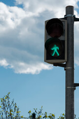 Green color on the traffic light with a beautiful sky