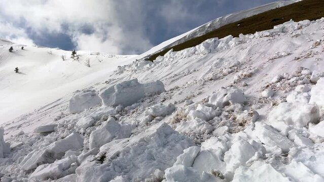 a powerful avalanche fell from an alpine slope in the Ukrainian Carpathians, huge blocks of snow are deadly for tourists, spring is coming.