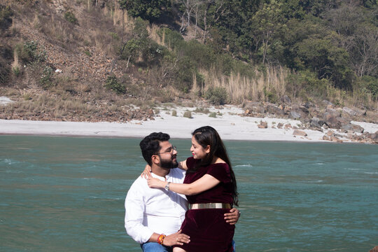 Ganges Serenade, A timeless embrace unfolds as the couple shares a tender moment face to face by the flowing waters