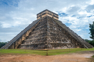 Sunny day with blue sky and white clouds. El Castillo (The Kukulkan Temple) of Chichen Itza, mayan pyramid in Yucatan, Mexico