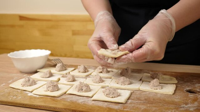 Pies are made from puff pastry and meat. Preparation of meat pies from puff pastry.