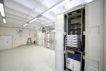 Telecom equipment with many cables and switches in big communication center