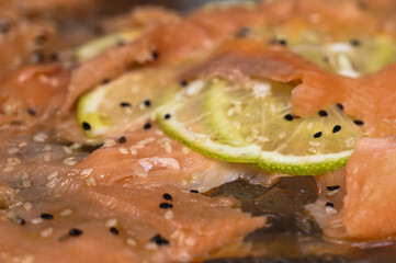 salmon steak with vegetables, salmon carpaccio, sliced ​​lemon, sesame, appetizer with salmon, grilled salmon steak with lemon
