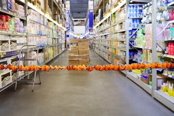 Orange bounding tape in empty modern big store with hygiene goods