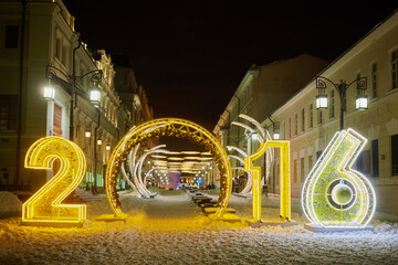  Illuminated gate in form of 2016 number between houses at Kamergersky Lane on winter night