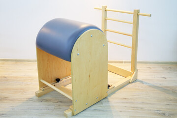 Wooden cylinder for pilates - gym equipment in fitness center with wooden floor