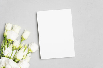 Wedding invitation card mockup with white flowers on grey