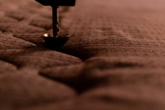 A machine embroidering the covers of a mattress
