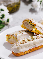eclairs with white glaze and poppy seeds close up
