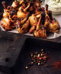 Grilled chicken legs on wooden tray