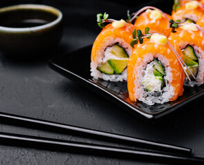 Philadelphia Sushi with avocado on black dish