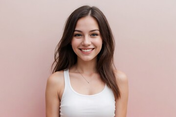 Happy young American woman wearing a white cropped tank top on a pink background with copy space. - obrazy, fototapety, plakaty