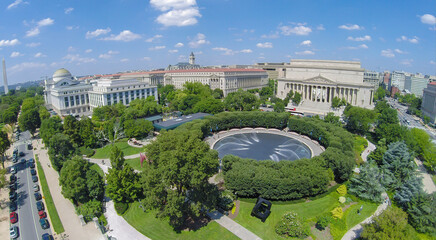 Fototapeta na wymiar Fountain in National Gallery of Art-Sculpture Garden near edifices of National Archive, Department of Justice and Museum of Natural History at summer sunny day. Aerial view
