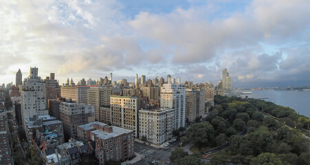 Fototapeta premium Cityscape with Riverside Park at summer evening. Aerial panorama