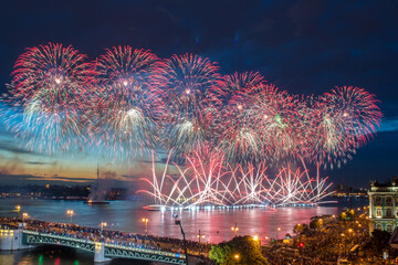 People on Palace Bridge look at beautiful fireworks at dark night in St. Petersburg, Russia. I have...