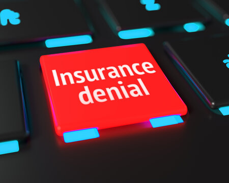 Computer keyboard with red Insurance denial button.