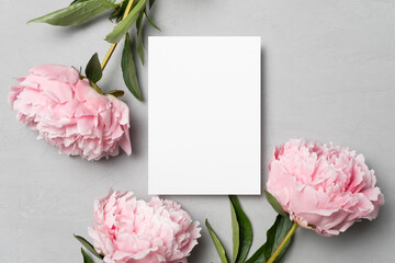 Invitation or greeting card mockup with peony flowers, flat lay with copy space © nikavera