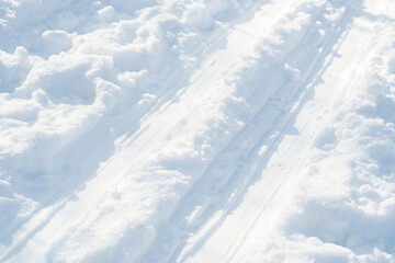 Close-up of ski tracks in the snow. Background on the theme of winter sports.