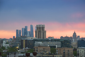 Many roofs, domes of churches and skyscrapers during sunset in Moscow, Russia