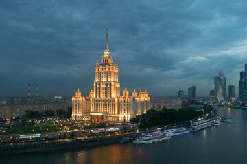 Obraz premium Illuminated Royal Hotel Radisson (Hotel Ukraina) near river at evening in Moscow