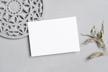 Fototapeta na wymiar Invitation or greeting card mockup, blank card with copy space and stylish botanical decor