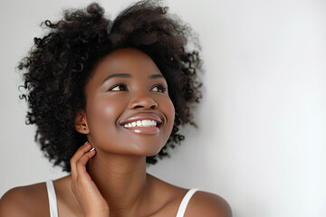 Woman smiling while touching her flawless glowy skin