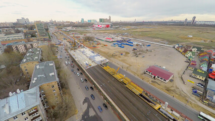  Road traffic near construction site of interchange not far from Spartak stadium at spring cloudy...
