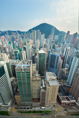 Fototapeta na wymiar Skyscrapers and tall buildings in business area and mountain far away in Hong Kong, China, view from China Merchants Tower