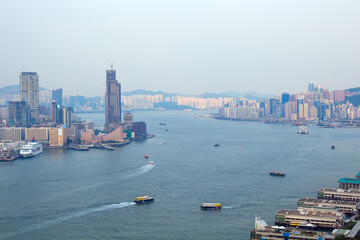 Skyscrapers on sea shore in business area, many ships at morning in Hong Kong, China, view from China Merchants Tower