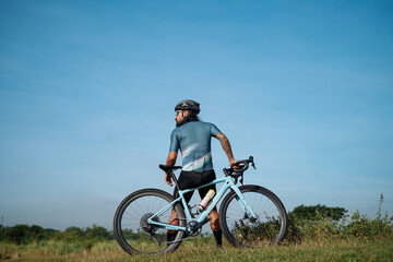 Fototapeta na wymiar A middle aged bearded cyclist with his gravel bike.