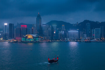 Evening high skyscrapers, river shore and ships in Hong Kong, China, view from Starhouse
