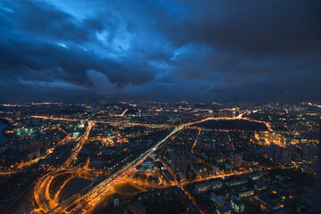 Fototapeta premium Highways, tall buildings at night and storm clouds in Moscow, Russia