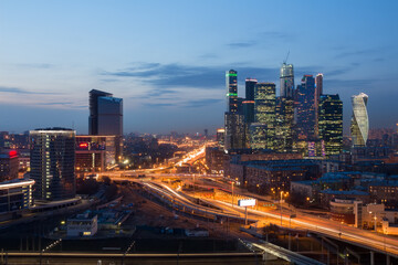  Futuristic Moscow International Business Center (MIBC) under construction and highway at evening....