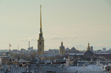 Fototapeta na wymiar Peter-Pavel Fortress building among roofs of other buildings in St. Petersburg, Russia