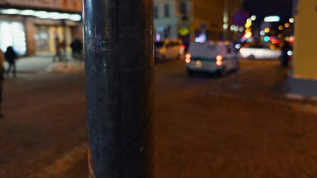 Police car with blurred automotive lighting speeding down dark street at night
