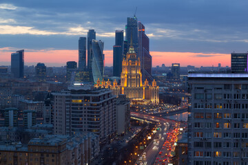 Hotel Ukraine, river and Moscow City business complex at evening in Moscow, Russia
